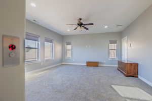 Carpeted empty room with recessed lighting and a ceiling fan