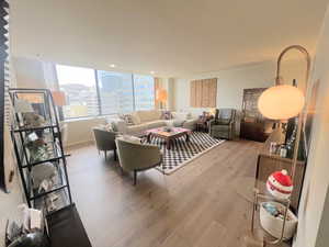 Living area featuring light wood-type flooring and a city view
