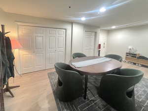 Dining space with light wood-style floors and recessed lighting