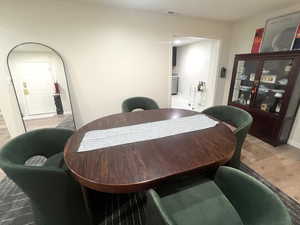 Dining area featuring light wood-style floors and arched walkways