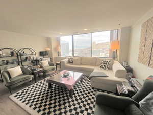 Living room featuring a wall of windows and wood finished floors