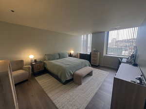 Bedroom featuring hardwood / wood-style flooring and baseboards