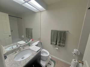 Bathroom with vanity, light wood-style flooring, and shower / bath combination