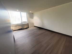 Spare room with wood finished floors, recessed lighting, and crown molding