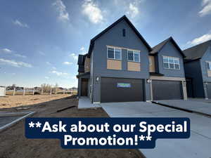 View of front of home featuring an attached garage and driveway