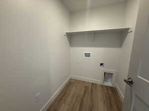Washroom with light wood-style floors, washer hookup, and electric dryer hookup