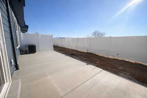 Fenced backyard featuring a patio area and a mountain view
