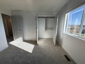 Unfurnished bedroom featuring carpet floors and a closet