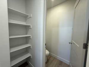 Bathroom featuring wood finished floors and baseboards