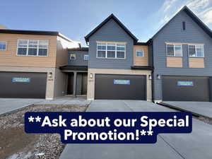 View of front facade featuring brick siding, concrete driveway, and a garage