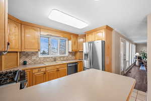 Kitchen featuring valley view & view to backyard,  newer stainless steel appliances and gas range
