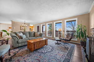 Living room with door to west facing deck and floor to ceiling windows