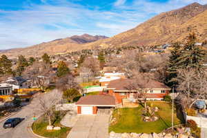 Aerial perspective of suburban area featuring a mountainous background
