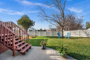 Fully fenced backyard with a patio area deck and garden