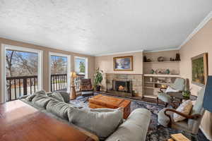 Living room with floor to ceiling windows, looking to backyard,  a gas fireplace, crown molding