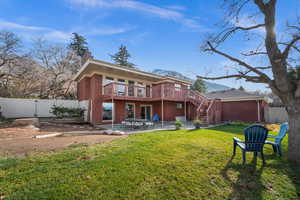 Back of property with a patio area, a fully fenced backyard and deck