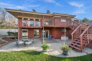 Back of house featuring a patio area, deck with stairs to backyard
