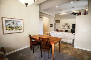 Tiled dining room featuring arched walkways, ceiling fan, recessed lighting, and carpet flooring