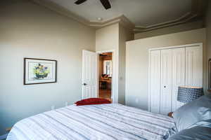 Bedroom with a ceiling fan and a closet