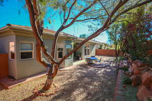 Rear view of property featuring stucco siding and a patio