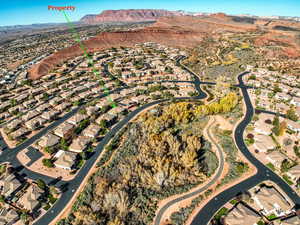 Aerial view of property and surrounding area with mountains and nearby suburban area