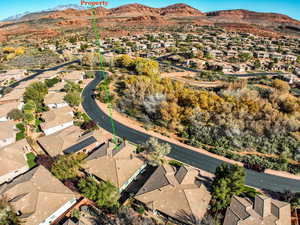 Aerial overview of property's location featuring nearby suburban area and mountains
