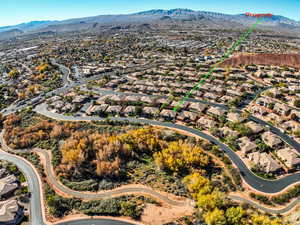 Aerial view of property and surrounding area with mountains and nearby suburban area