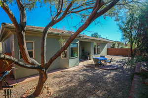 Back of property with stucco siding and a patio area