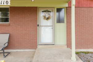 Doorway to property with brick siding