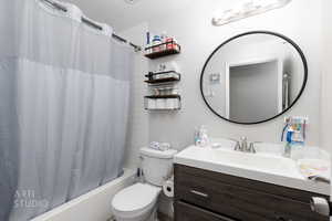 Bathroom featuring shower / bath combo and vanity