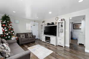 Living area featuring dark wood-style floors and recessed lighting