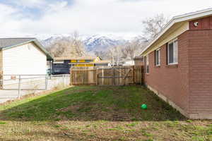 Fenced backyard with a mountain view and a gate