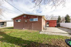 Back of property with a patio area and brick siding