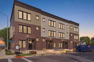 View of property at dusk