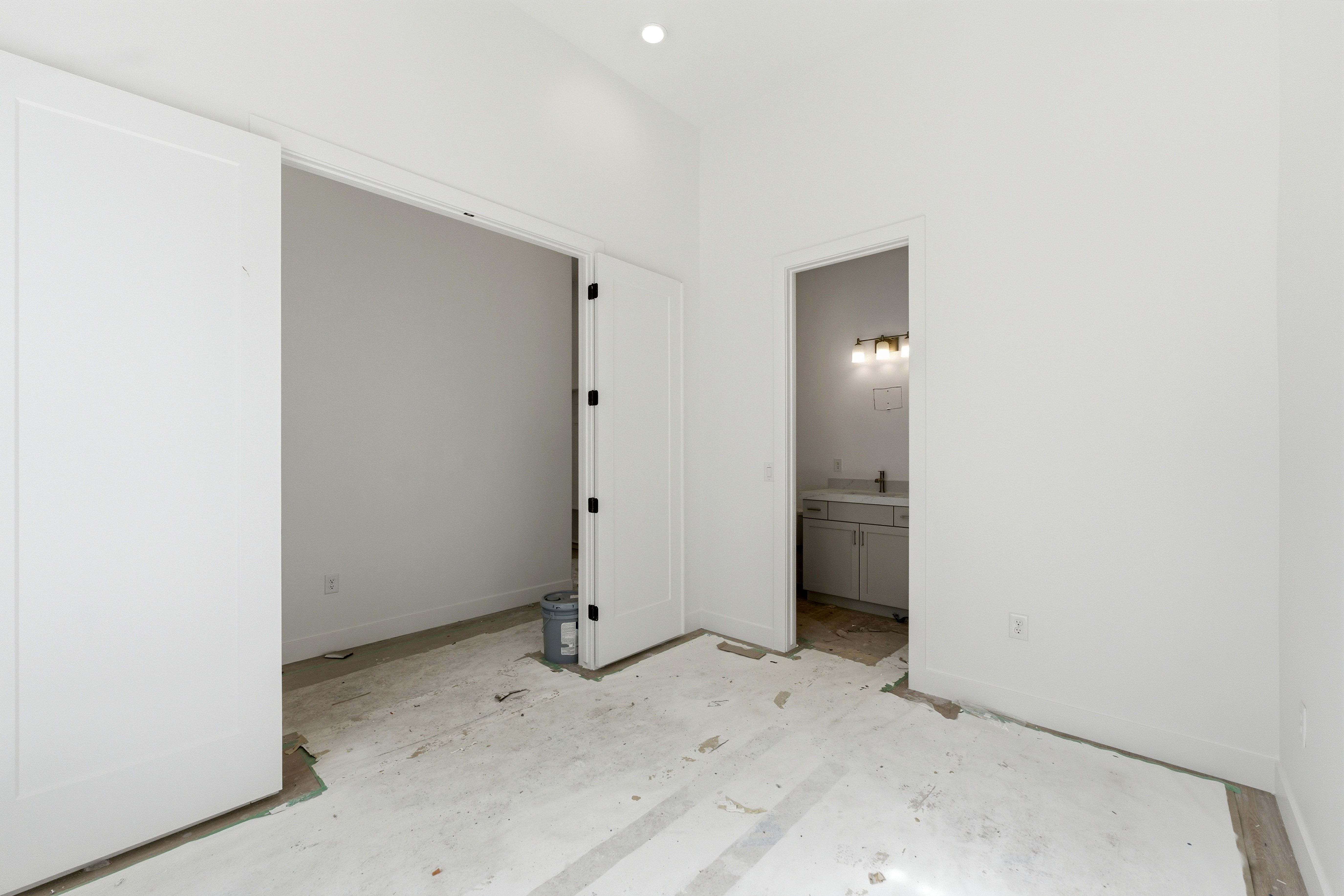 Unfurnished bedroom with baseboards and ensuite bath