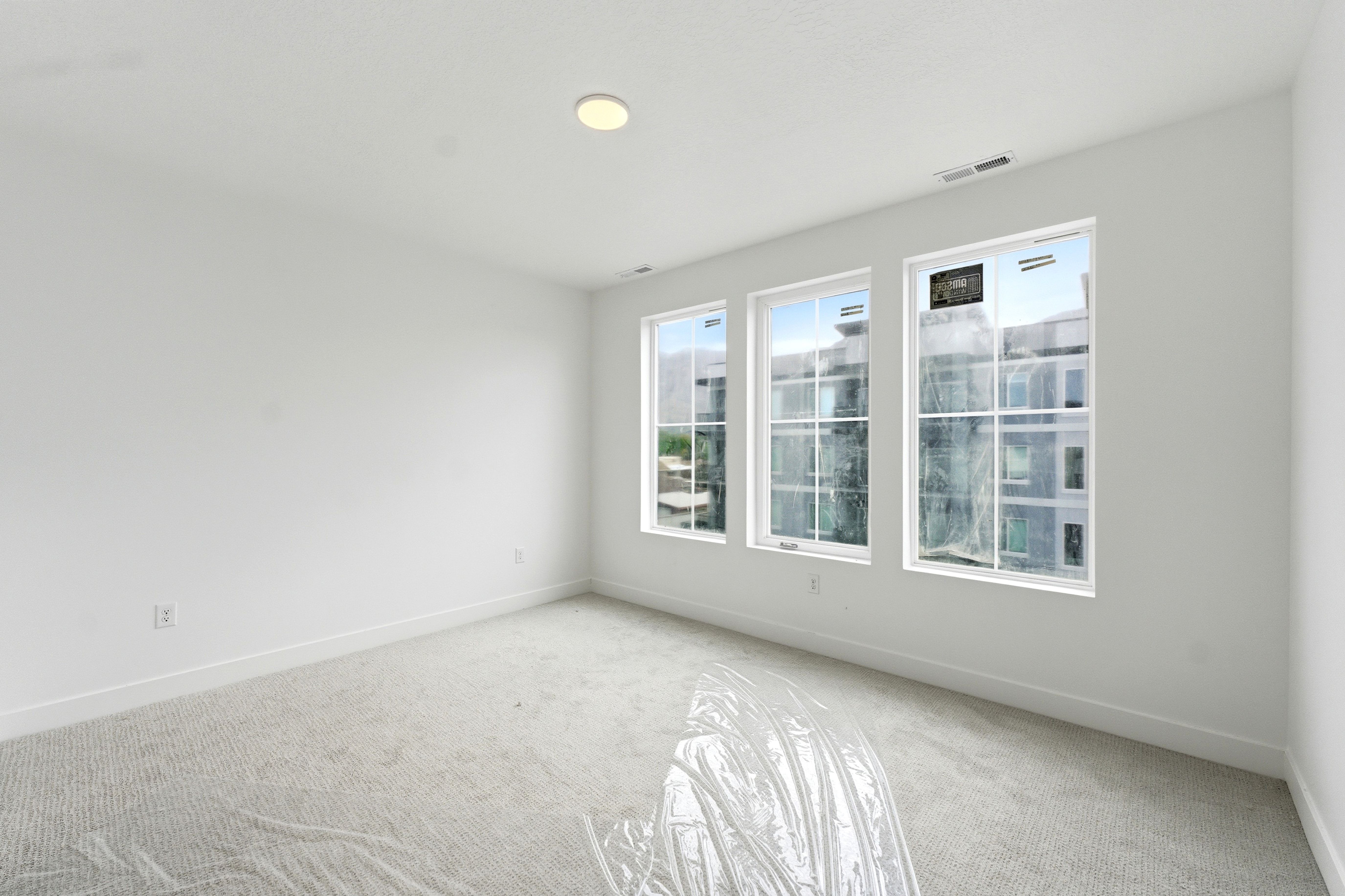 Carpeted empty room featuring baseboards