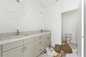 Full bath featuring double vanity and toilet