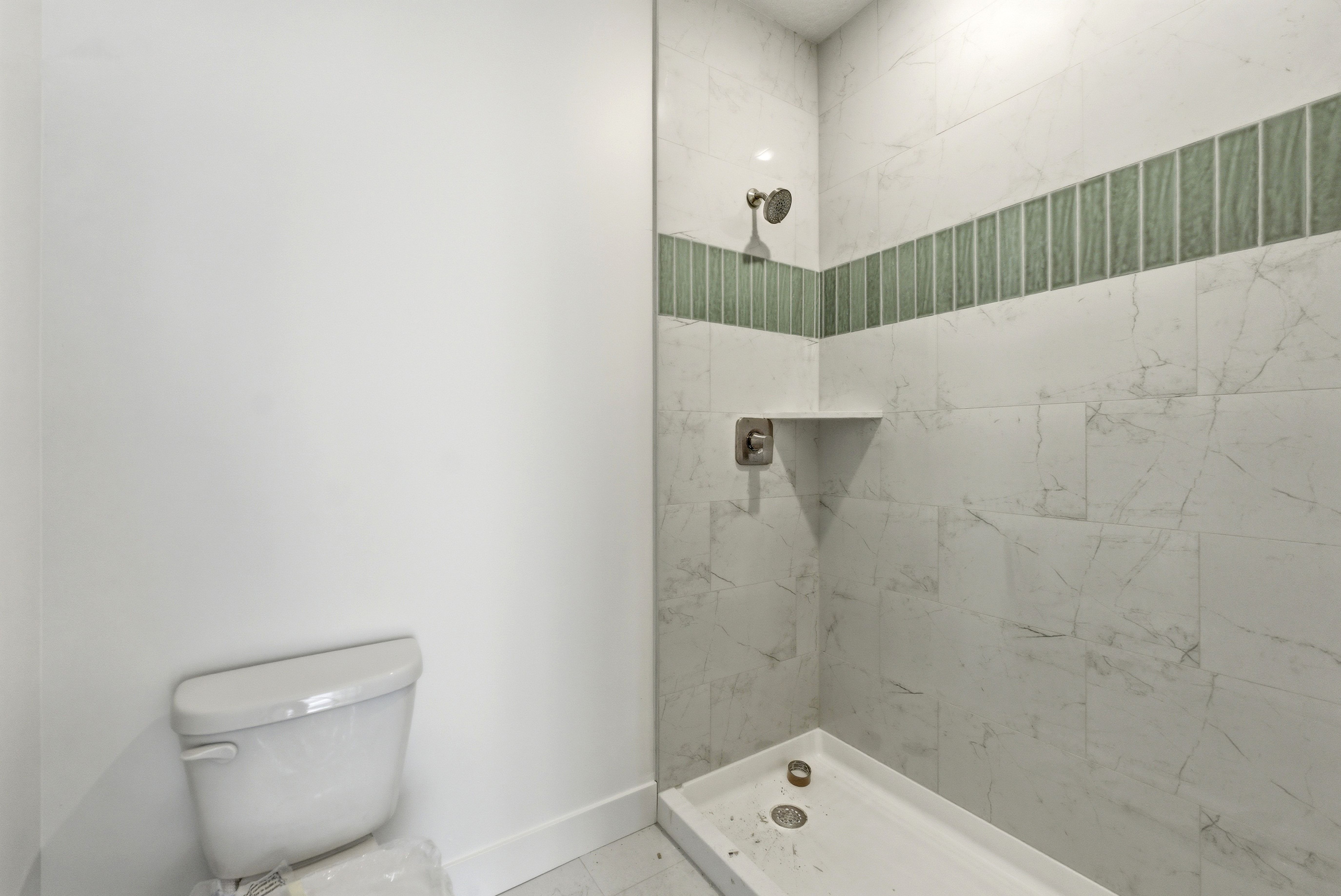 Bathroom with a tile shower and toilet