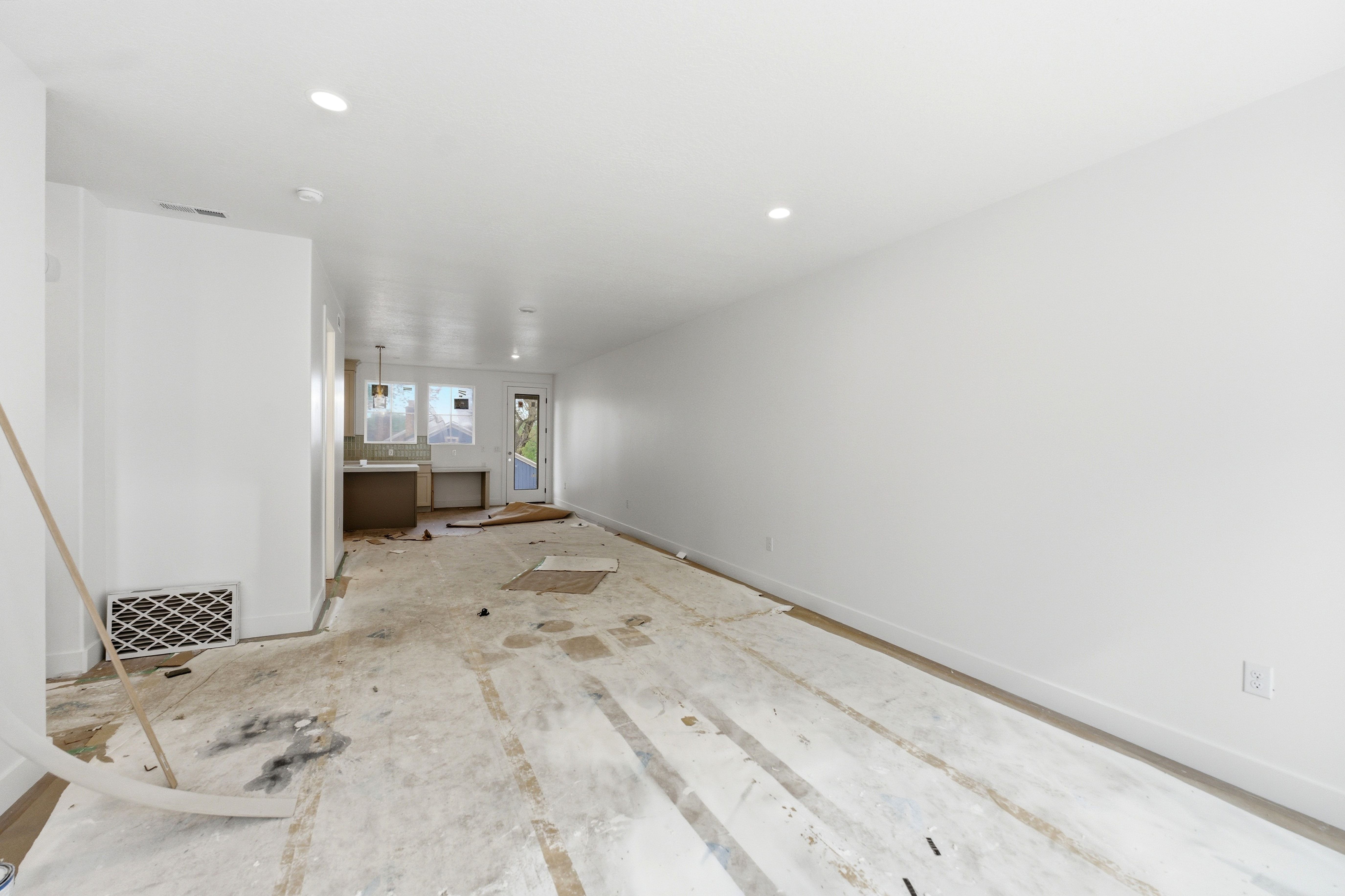 Unfurnished living room with baseboards and recessed lighting