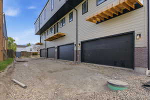 View of property exterior with brick siding and an attached garage
