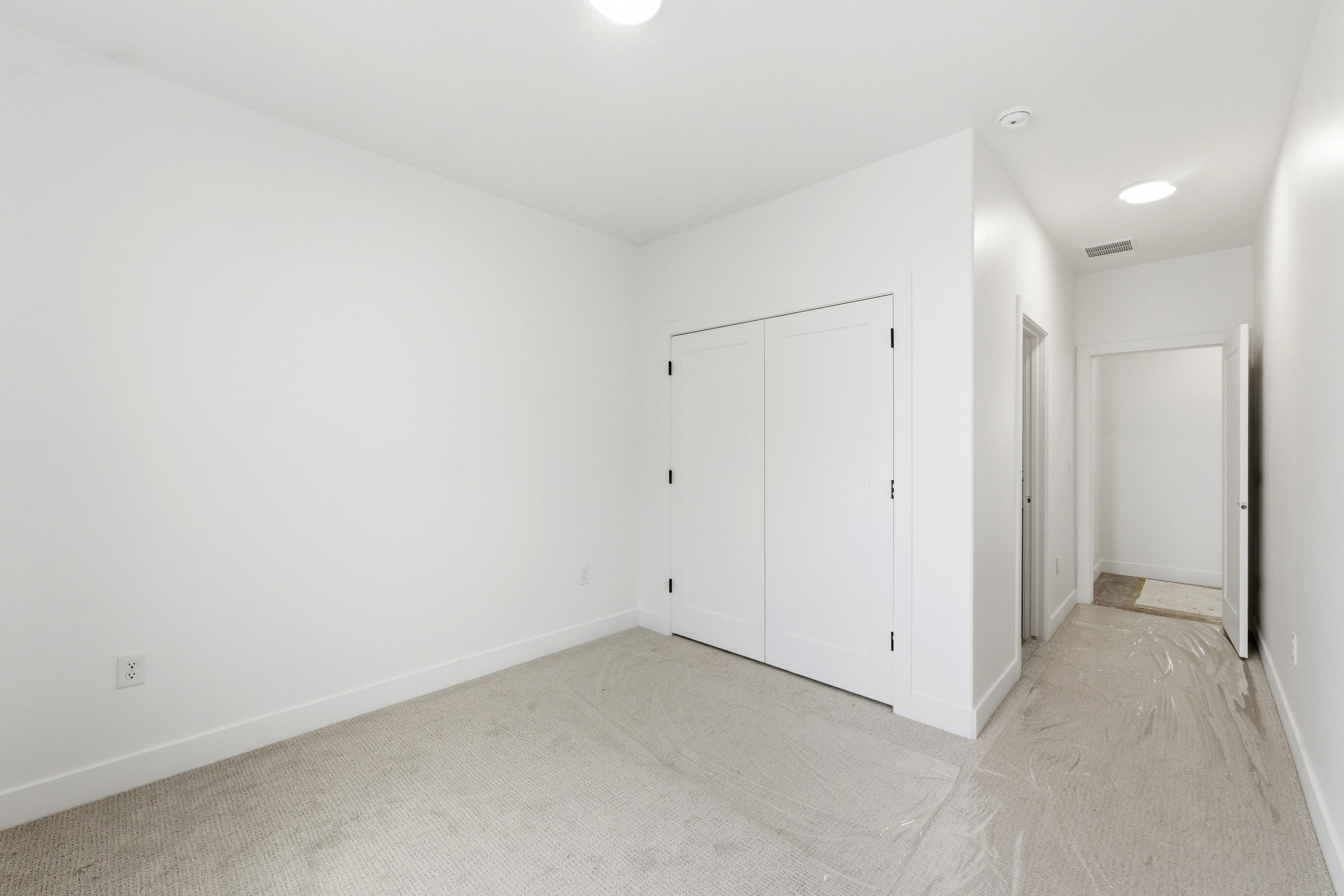 Unfurnished bedroom with light carpet, a closet, and recessed lighting