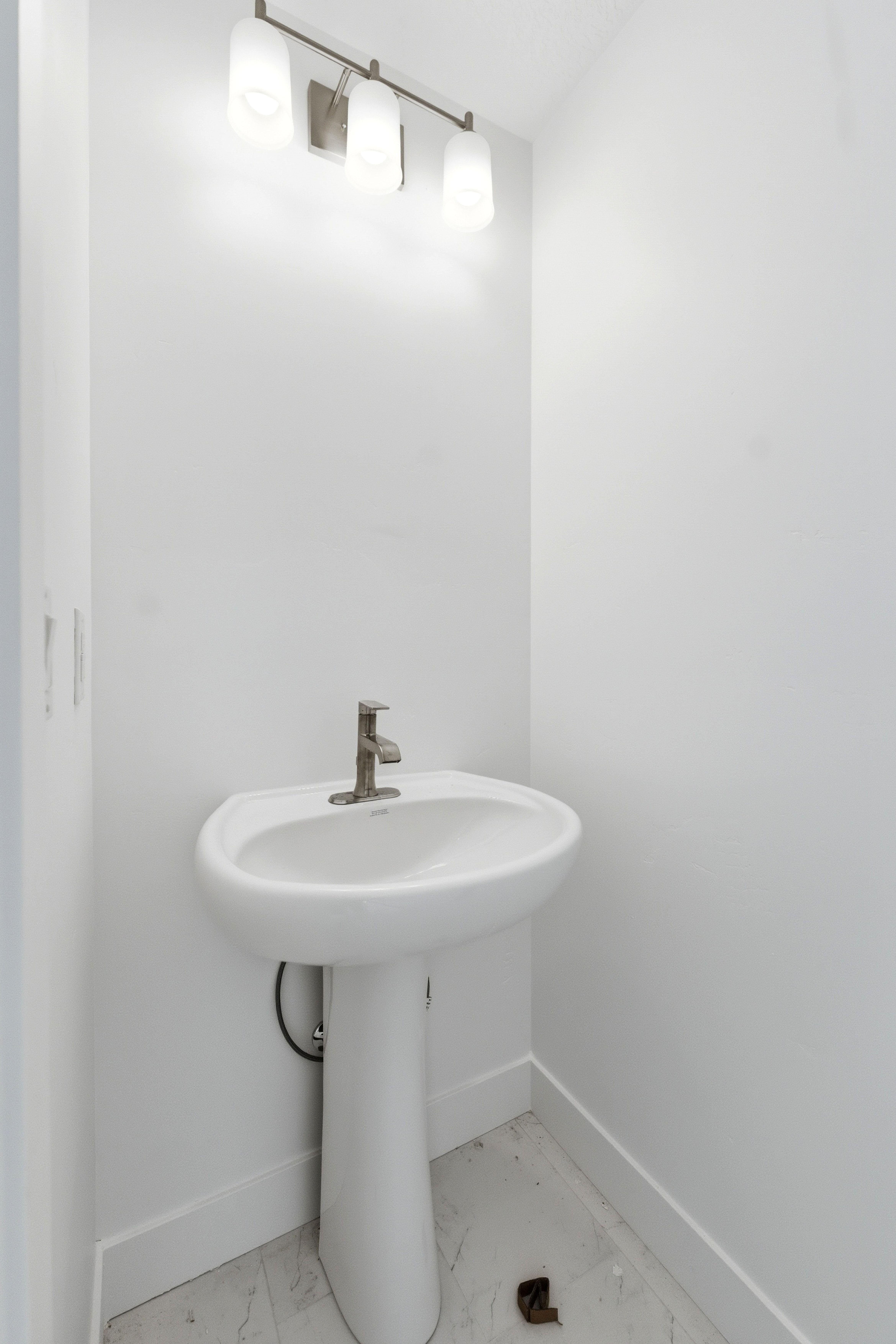 Bathroom with baseboards and light marble finish floors