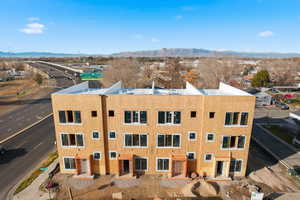 Bird's eye view of a mountain backdrop and apartment complex / building