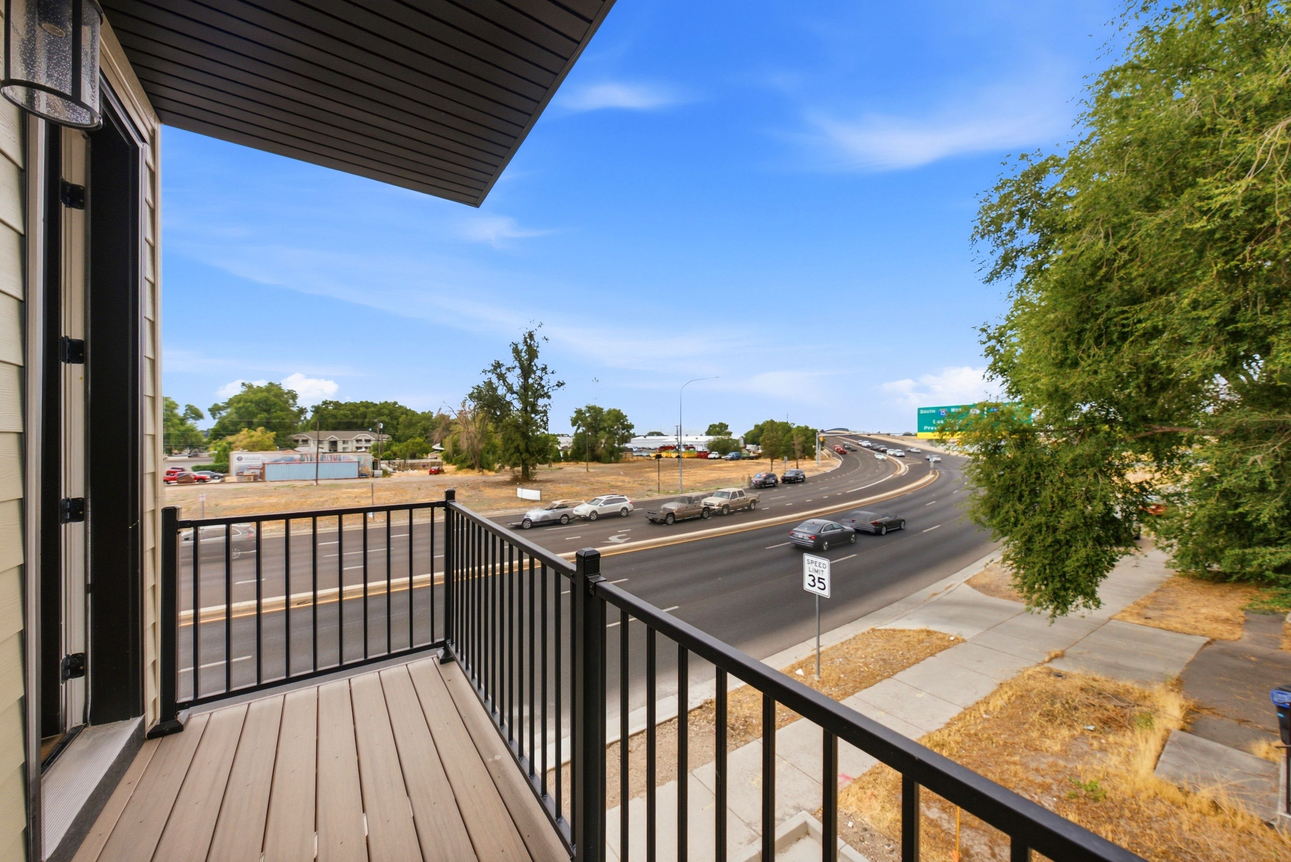 Balcony featuring composite decking and black metal railing