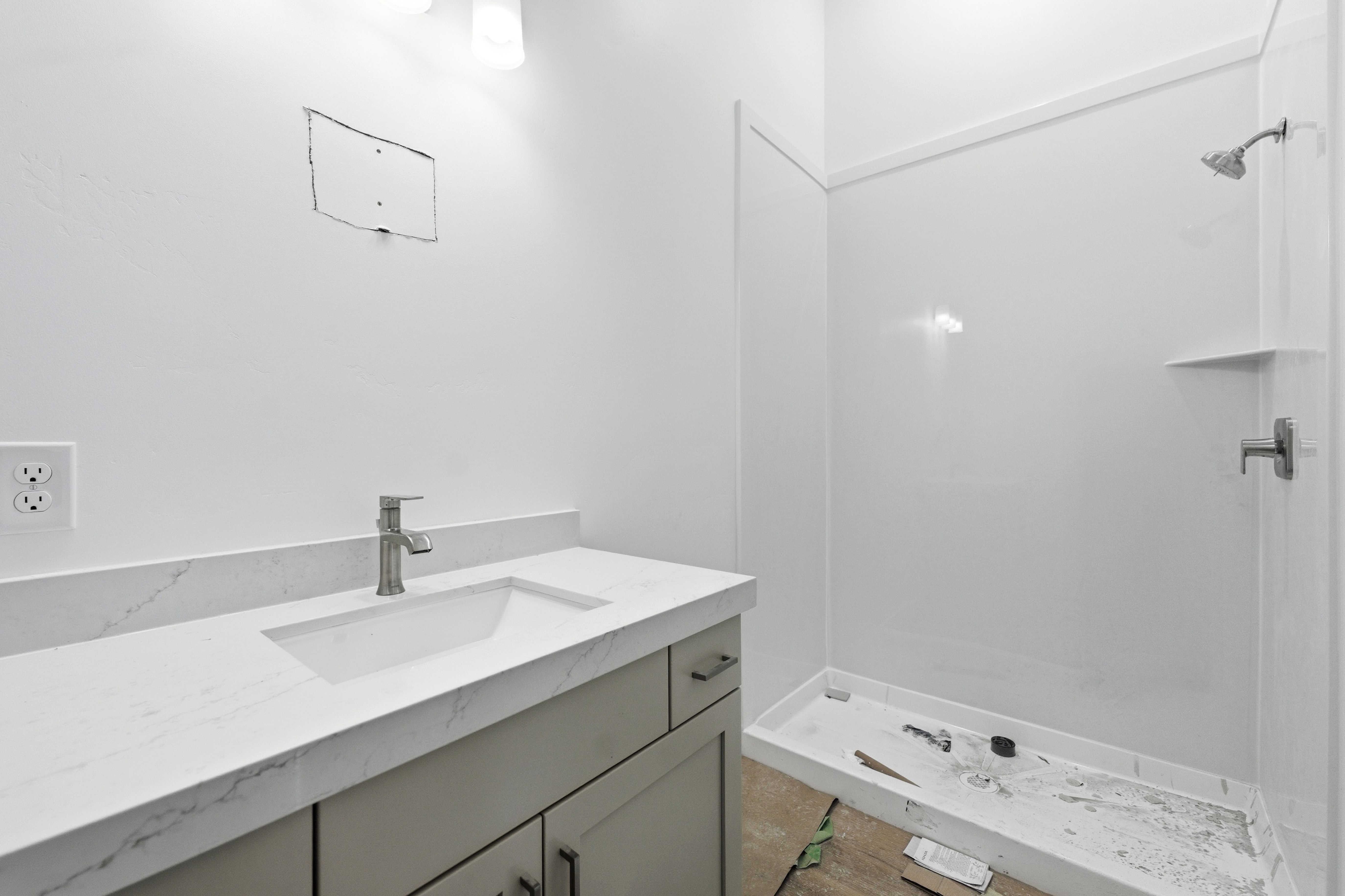Full bathroom with vanity and a shower stall