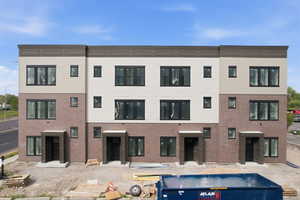Rear view of house featuring brick siding