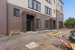 Property entrance featuring brick siding