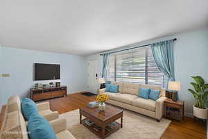Living room with wood finished floors and baseboards