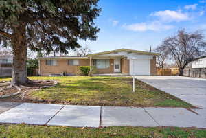 Ranch-style house with brick siding, concrete driveway, and a garage