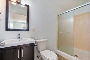 Bathroom featuring vanity and a shower stall